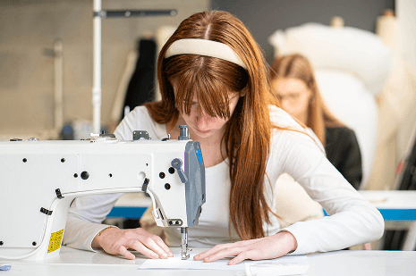Étudiante à la machine à coudre